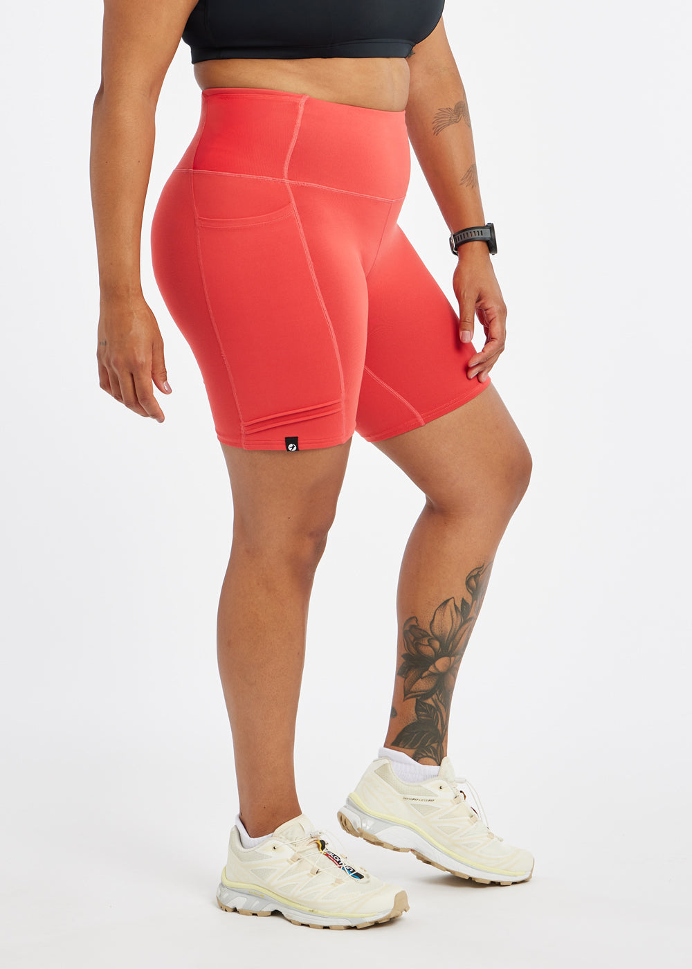 Woman wearing red orange compression shorts in size 12, side view