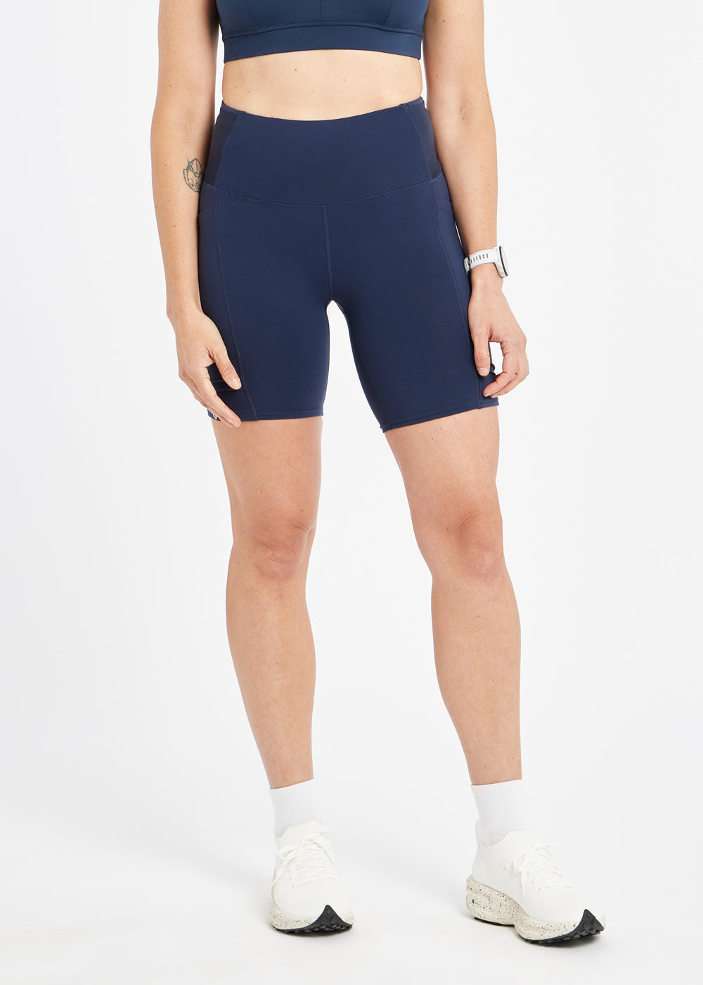 Woman wearing dark blue compression shorts in size 6, front view