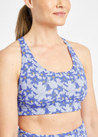 Woman wearing blue with blue flower print sports bra in size 6, close up of flower print