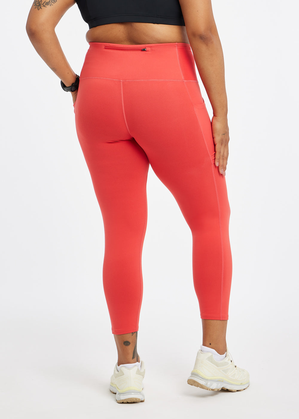 Woman wearing red orange compression tights in size 12, back view