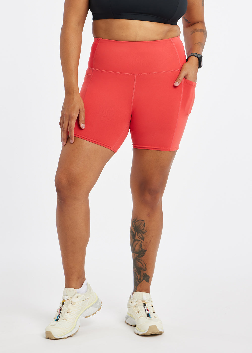 Woman wearing red orange compression shorts in size 12, alternate front view