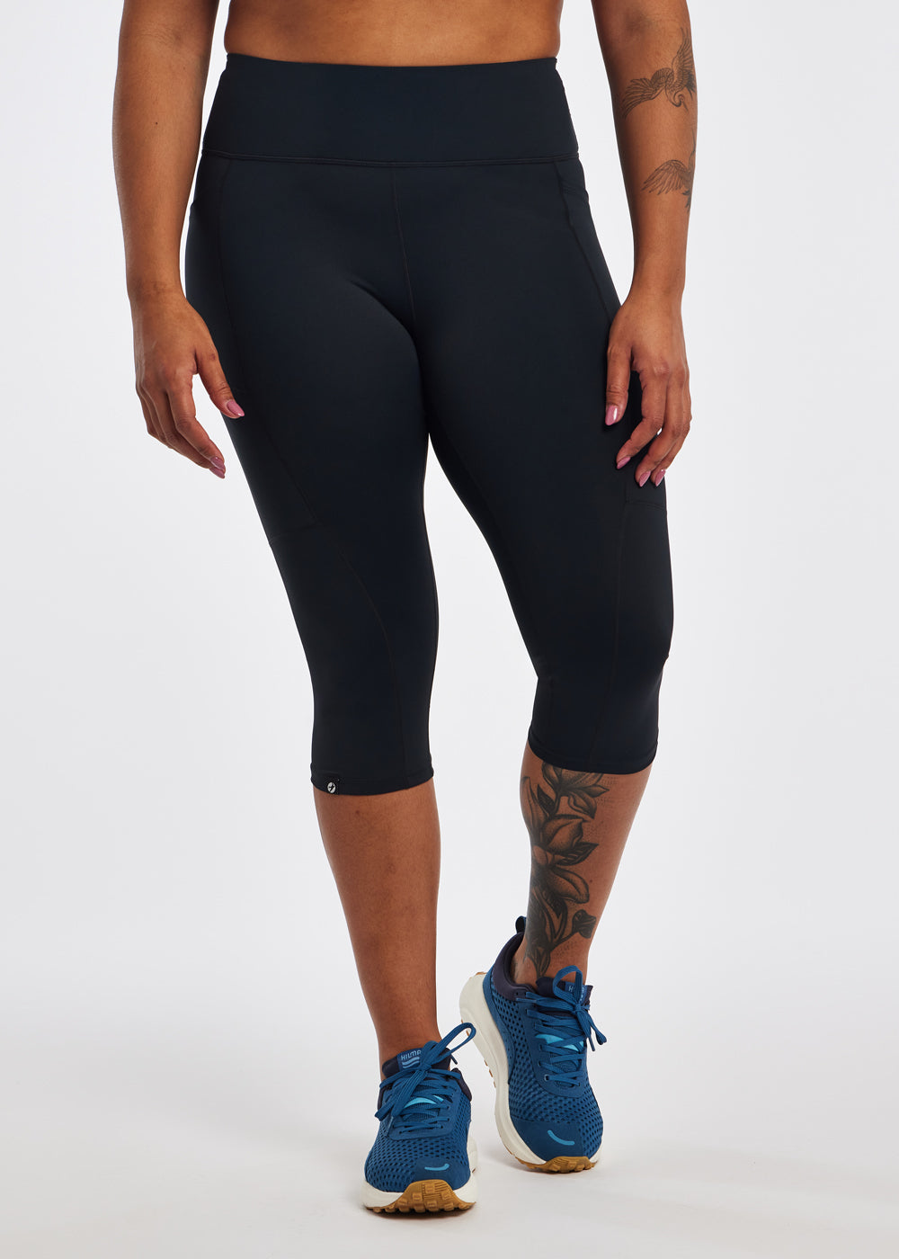 Woman wearing black running knickers in size 12, front view