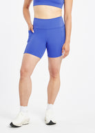 Woman wearing blue compression shorts in size 6, front view