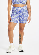 Woman wearing blue with blue floral print compression shorts in size 12, front view
