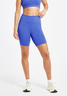 Woman wearing blue compression shorts in size 6, front view