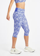 Woman wearing blue running knickers with blue flower print in size 6, side view
