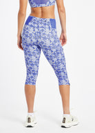 Woman wearing blue running knickers with blue flower print in size 6, back view