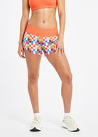 Roga 4" Running Shorts in colorful checkered print with orange waistband, front view