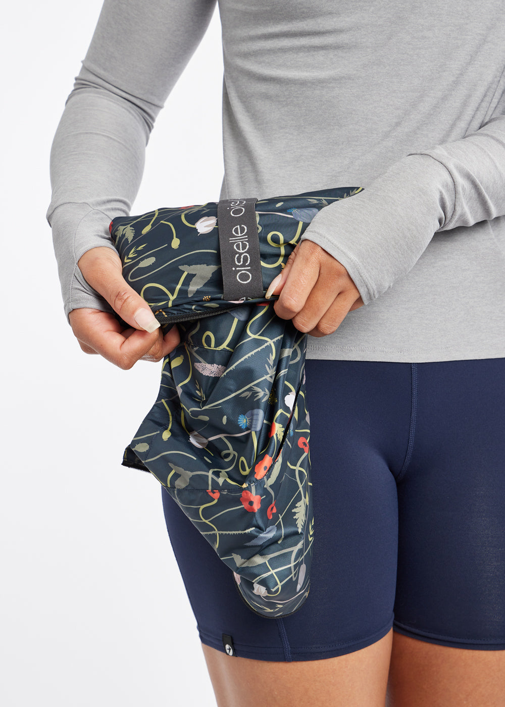 Whirlwind Vest, a wind resistant running vest in black print, packable view