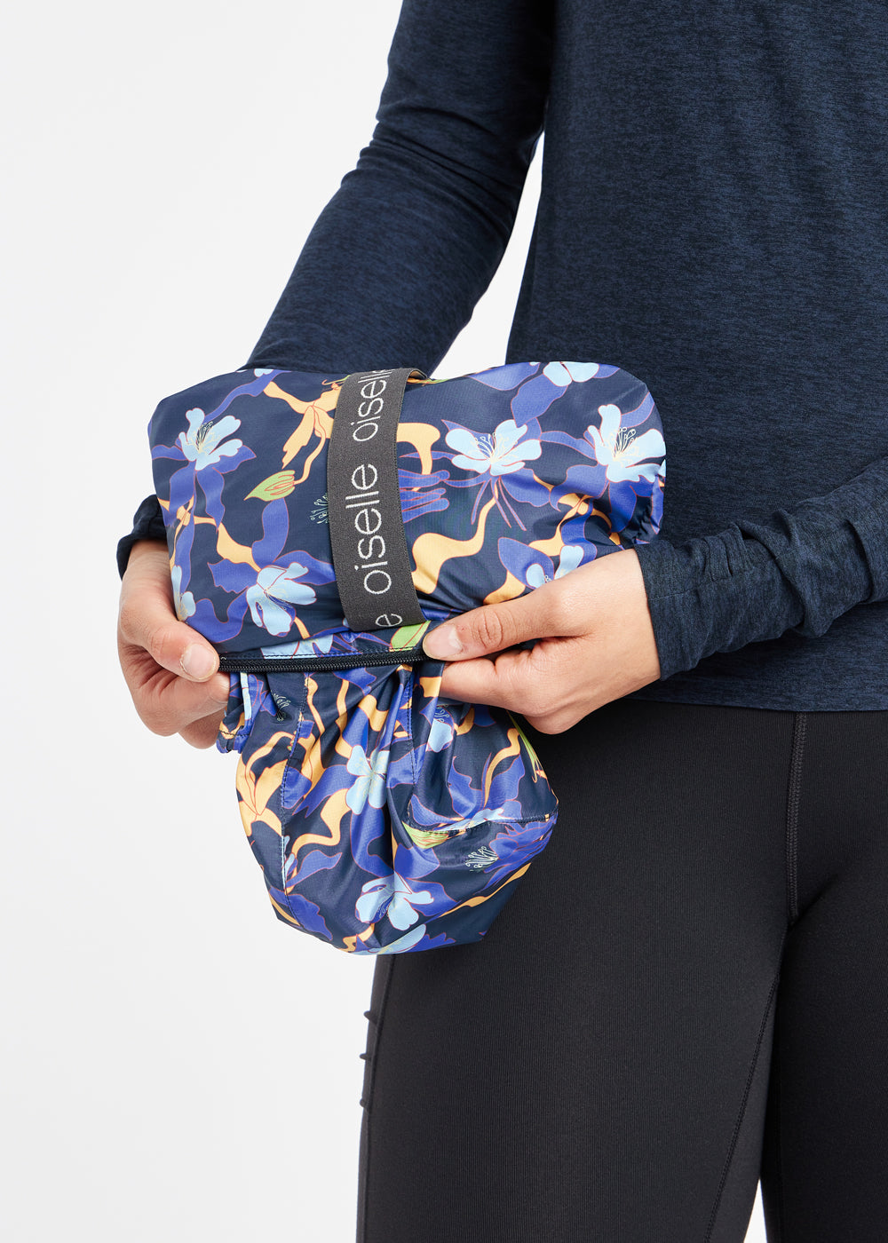 Whirlwind Running Jacket in Ink Blue Aquila Bloom Floral Print, packable detail view