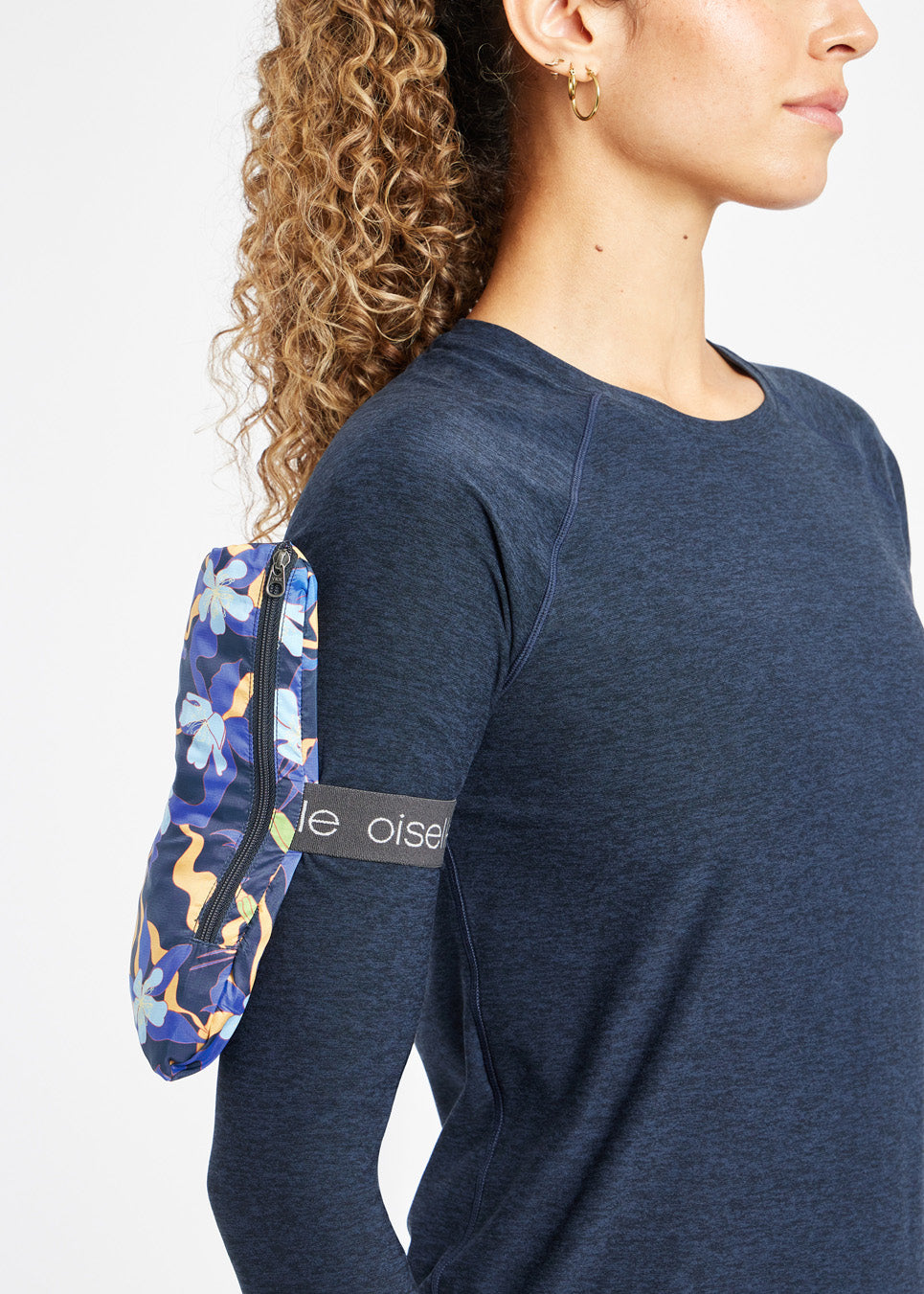 Whirlwind Running Jacket in Ink Blue Aquila Bloom Floral Print, packable design detail view